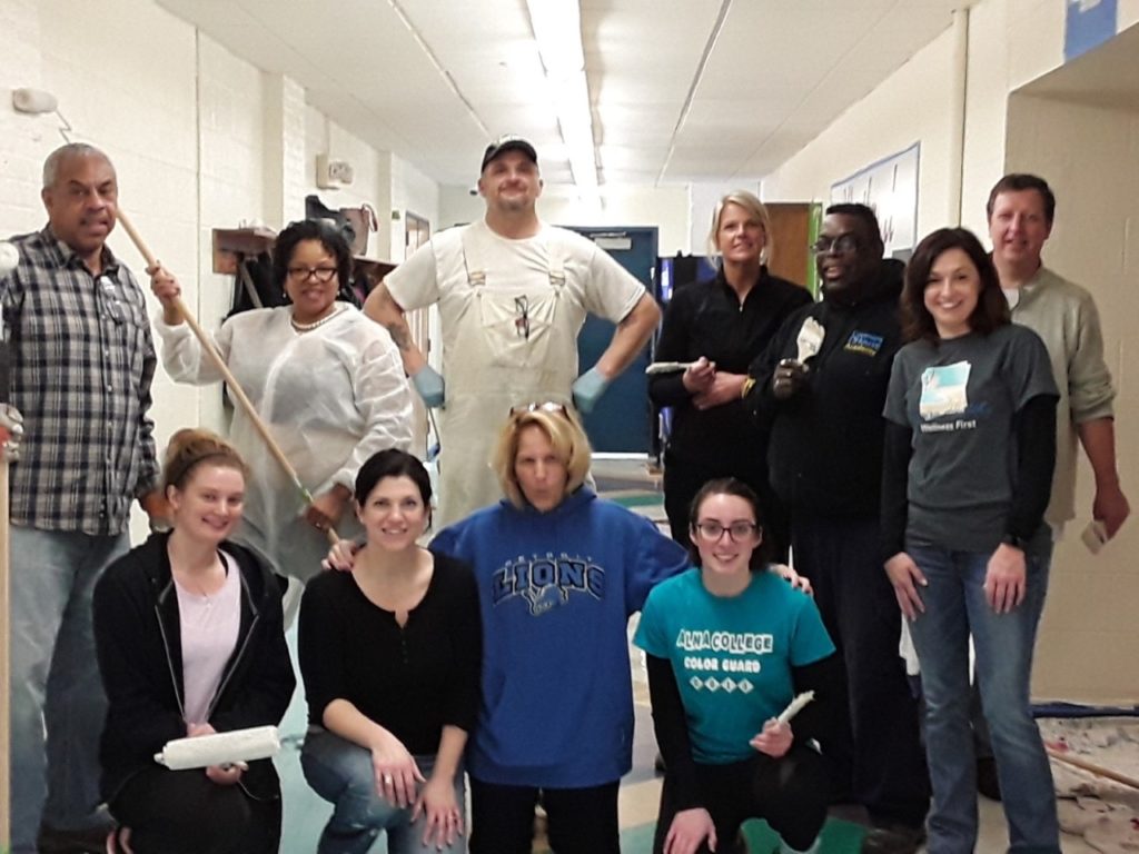 employees who volunteered their day off to paint the halls of a charity they partner with. 