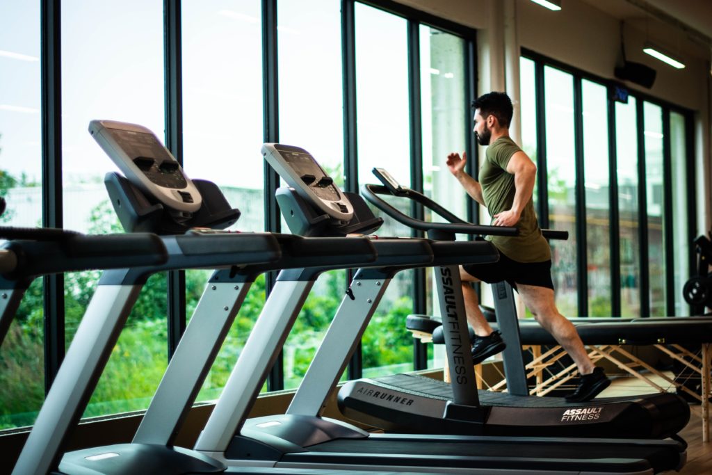 man running on a treadmill in a gym 