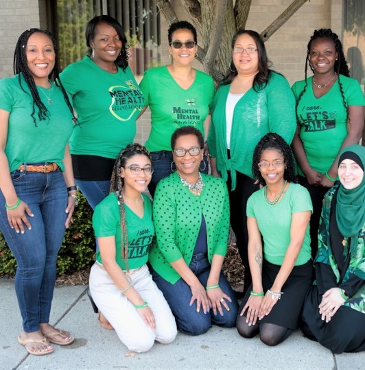Staff at Nneka J Owens and Associates Counseling Office wearing green to celebrate Mental Health Awareness month. 