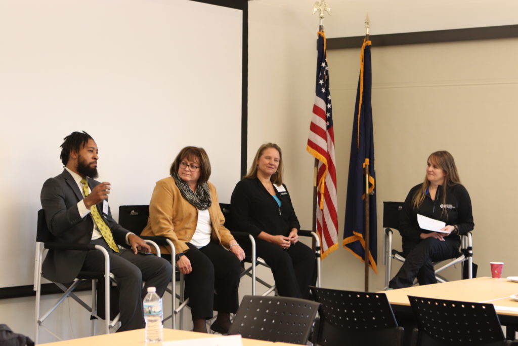 panelists speaking at an event. 