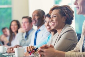 woman sitting in a meeting about resiliency 