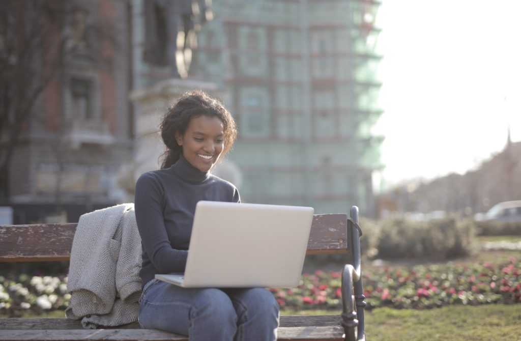 woman sitting outside working on her computer