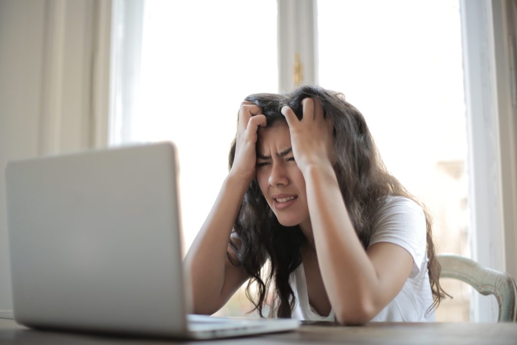 woman stressed out looking at the computer