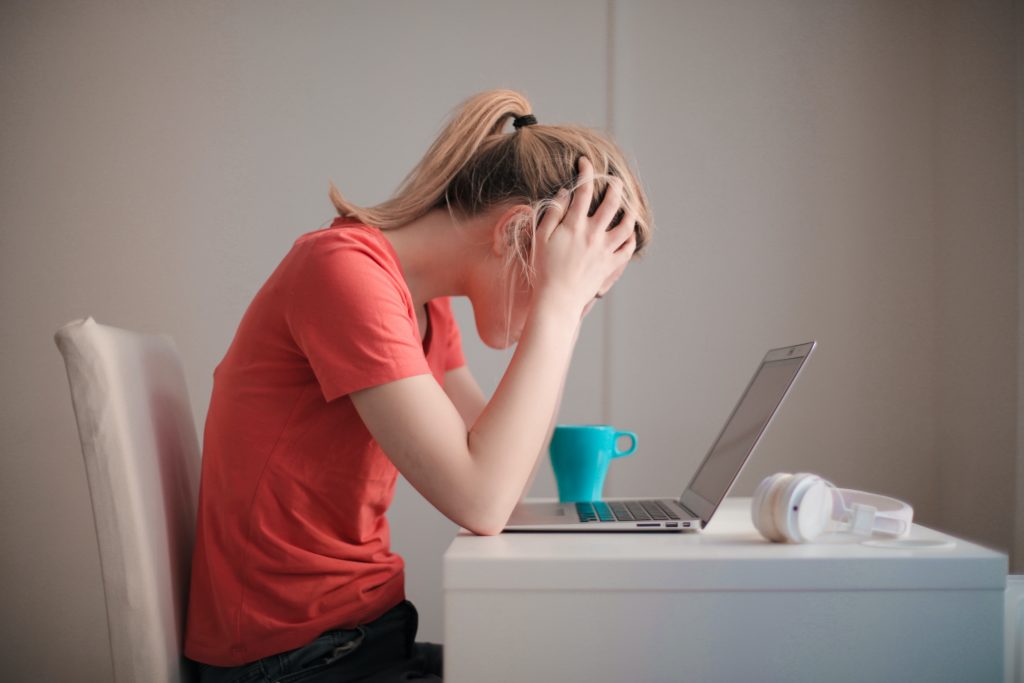 stressed woman looking at her computer 