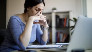 stressed woman sitting in front of her computer