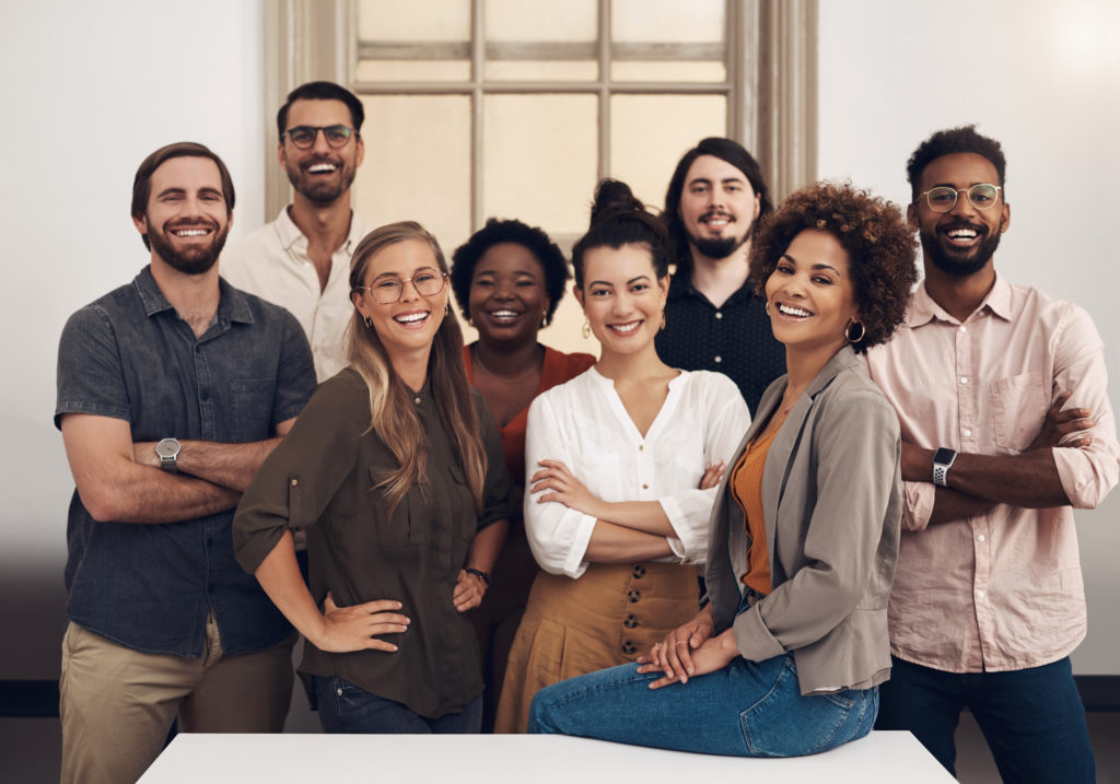 group of employees smiling together at work